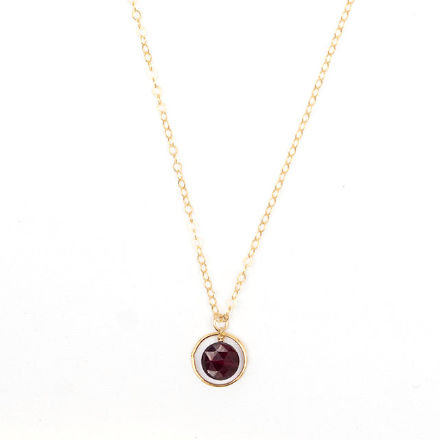 Garnet halo birthstone necklace by PHYNE featuring a square-shaped pendant with a central garnet stone and halo setting.