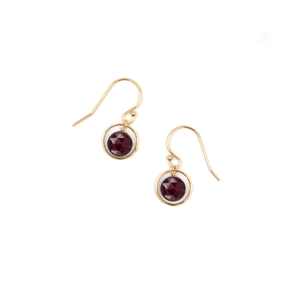PHYNE halo birthstone earrings featuring a vibrant garnet gemstone set in a delicate halo design.