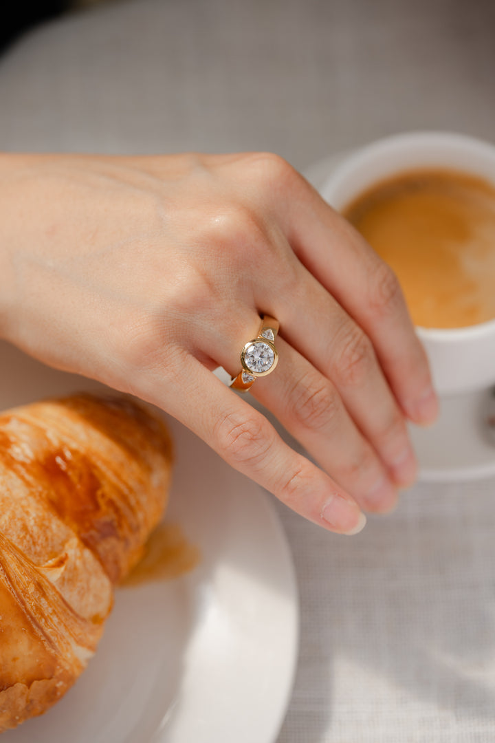 Round diamond bezel three-stone wide band engagement ring featuring 2.2 ctw diamonds in a sleek ring setting.