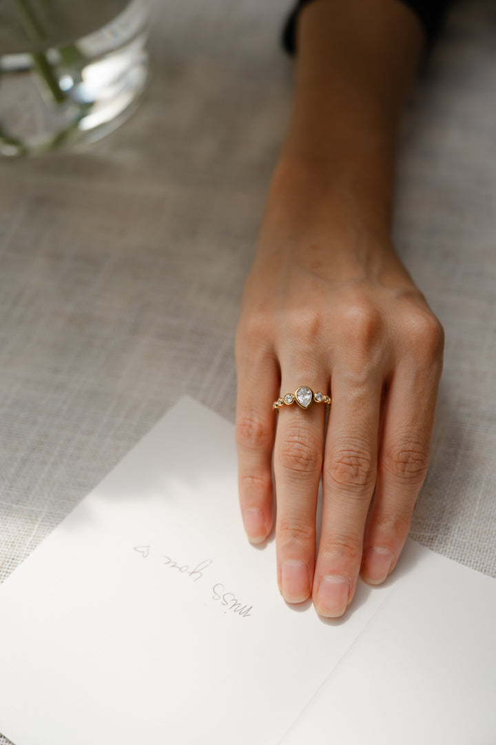 1 ctw pear diamond 7-stone bezel engagement ring
