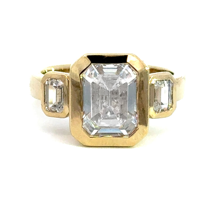 4.2 ctw emerald-cut diamond three-stone bezel wide band engagement ring