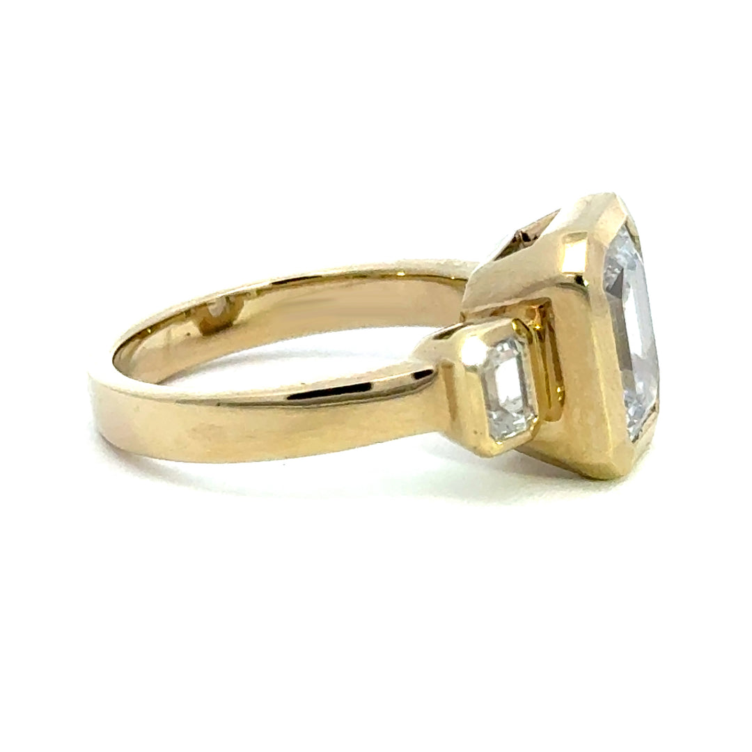 4.2 ctw emerald-cut diamond three-stone bezel wide band engagement ring
