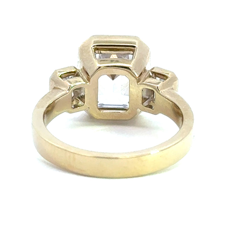 4.2 ctw emerald-cut diamond three-stone bezel wide band engagement ring