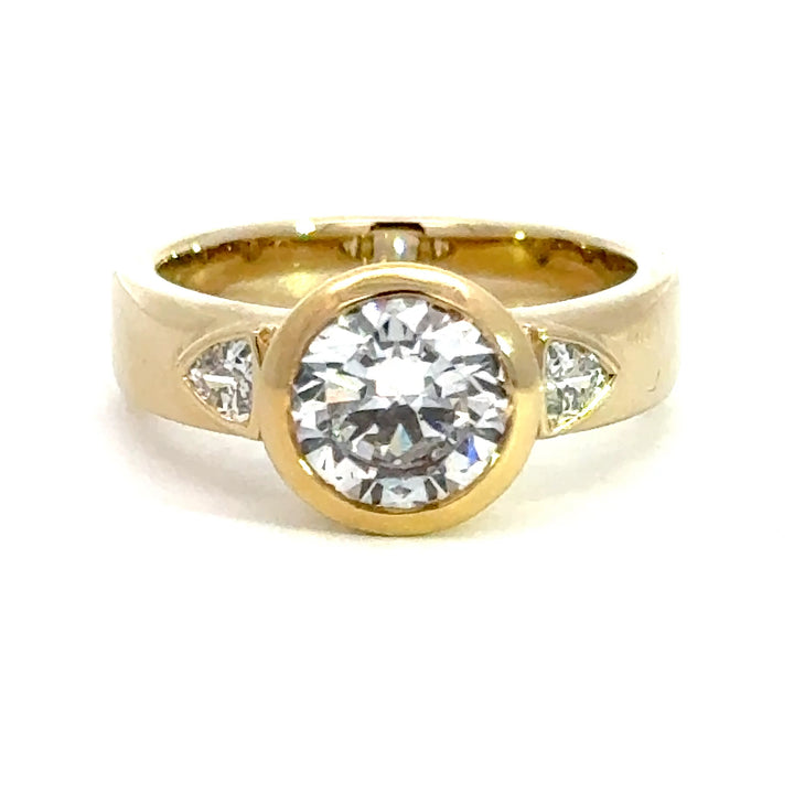 2.2 ctw round diamond bezel three-stone trillion wide band engagement ring