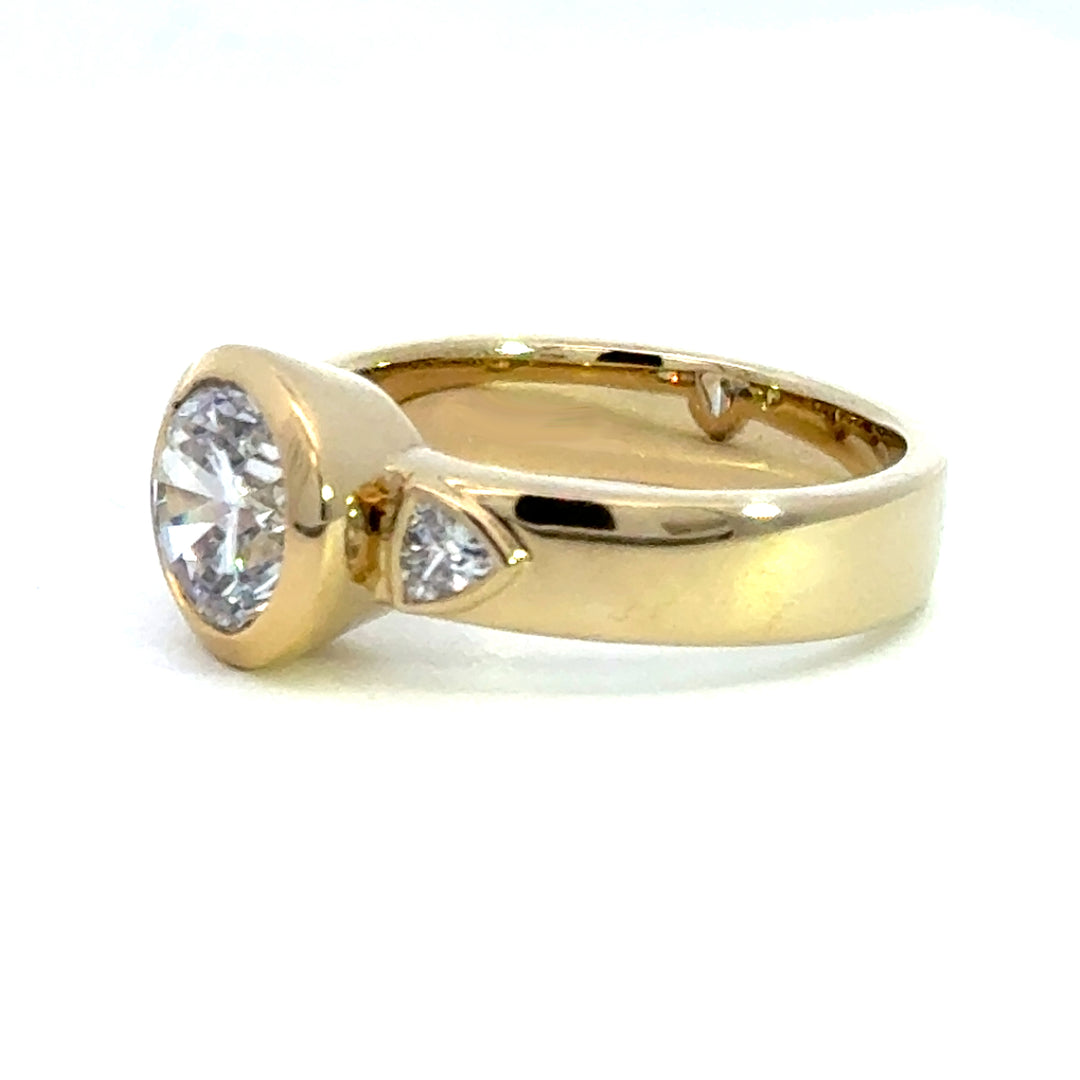 2.2 ctw round diamond bezel three-stone trillion wide band engagement ring