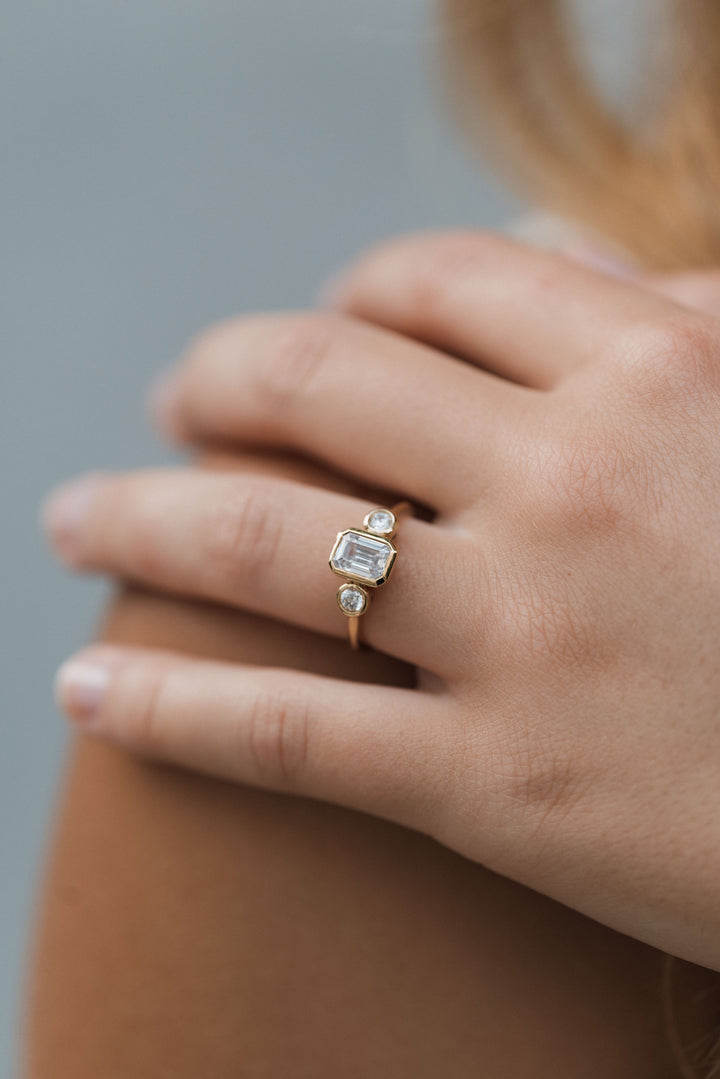 1 1/5 ctw emerald cut diamond 3-stone bezel engagement ring