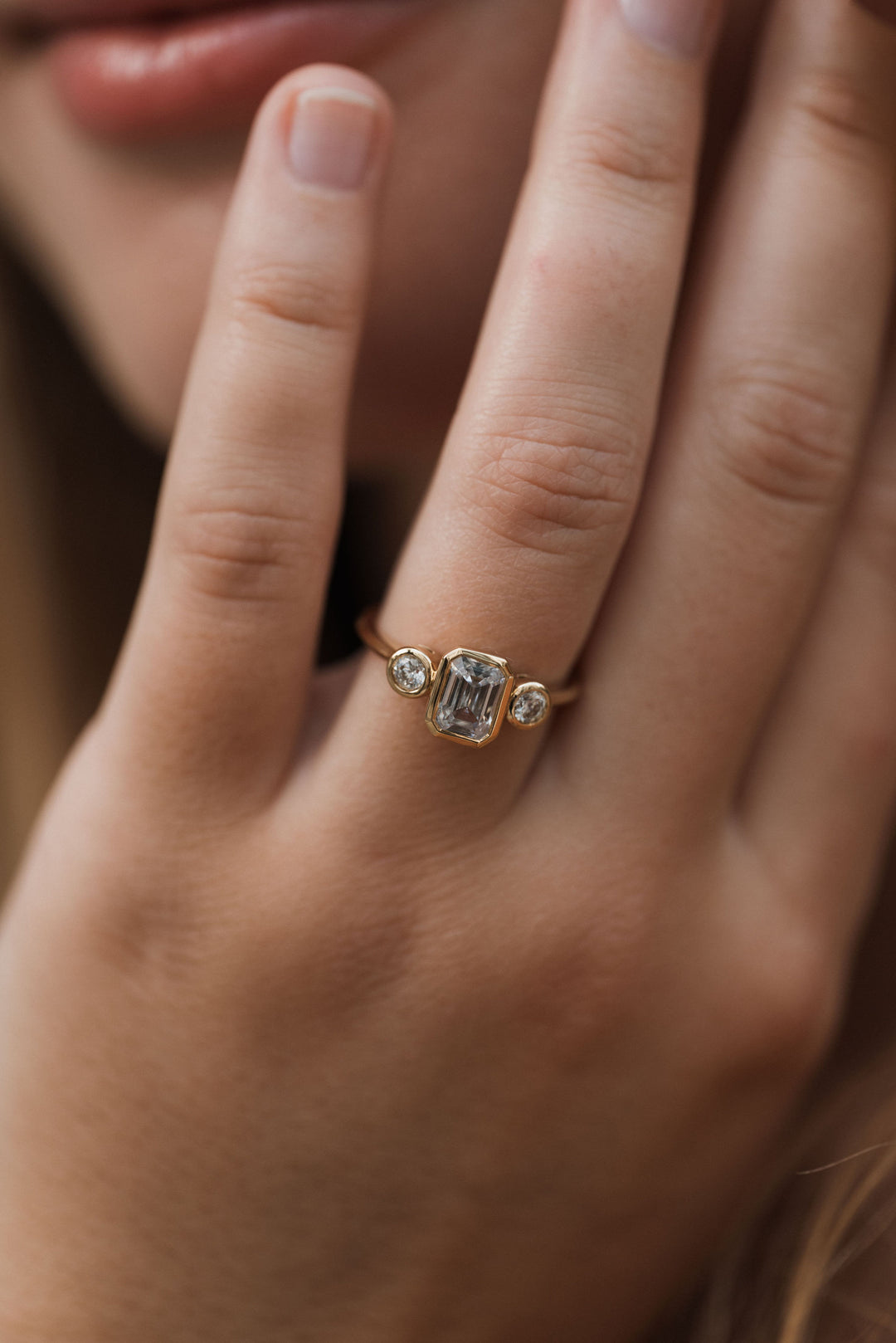 1 1/5 ctw emerald cut diamond 3-stone bezel engagement ring