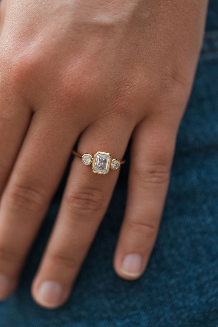 1 1/5 ctw emerald cut diamond 3-stone bezel engagement ring