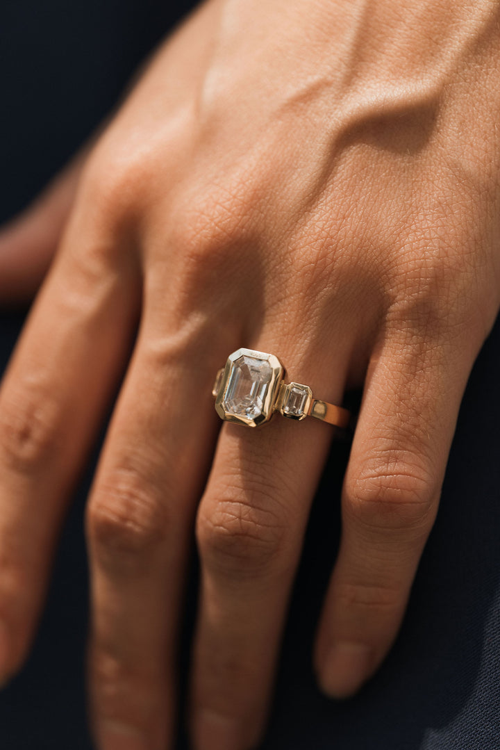 4.2 ctw emerald-cut diamond three-stone bezel wide band engagement ring