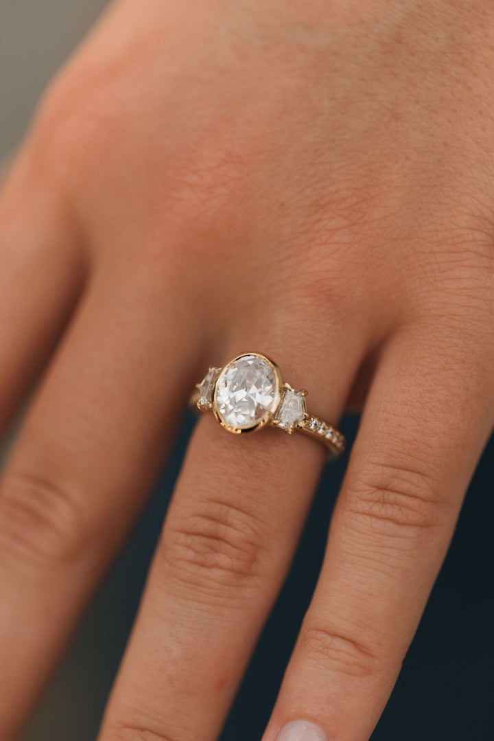 4.1 ctw oval diamond three-stone bezel pentagon with pave band engagement ring