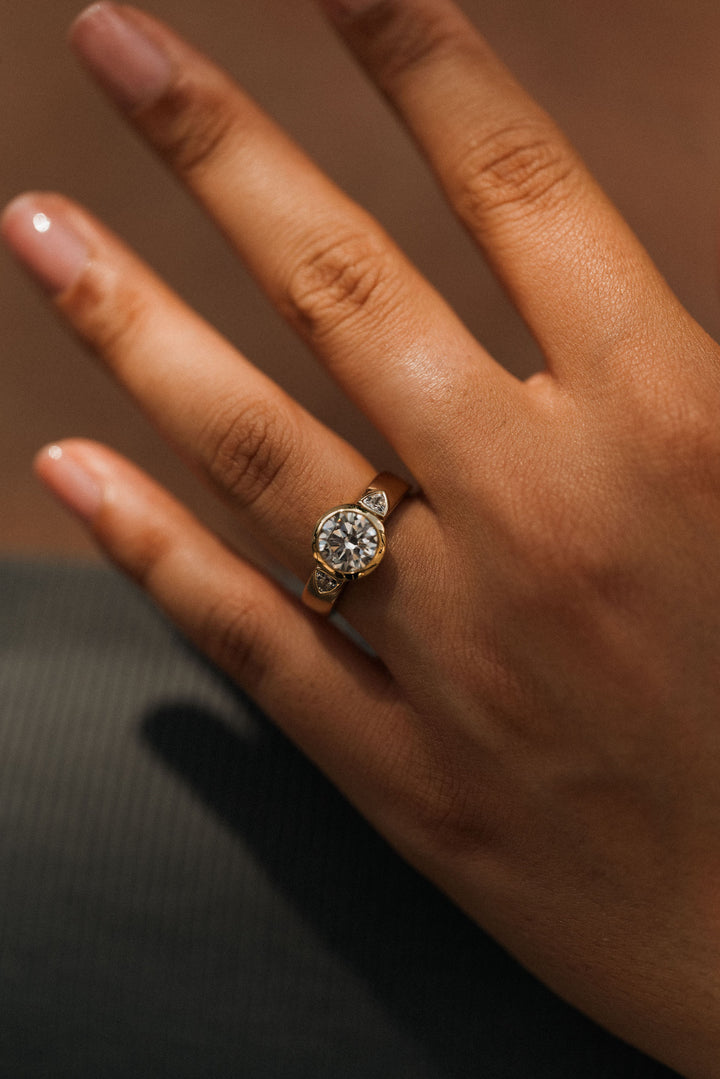 2.2 ctw round diamond bezel three-stone trillion wide band engagement ring