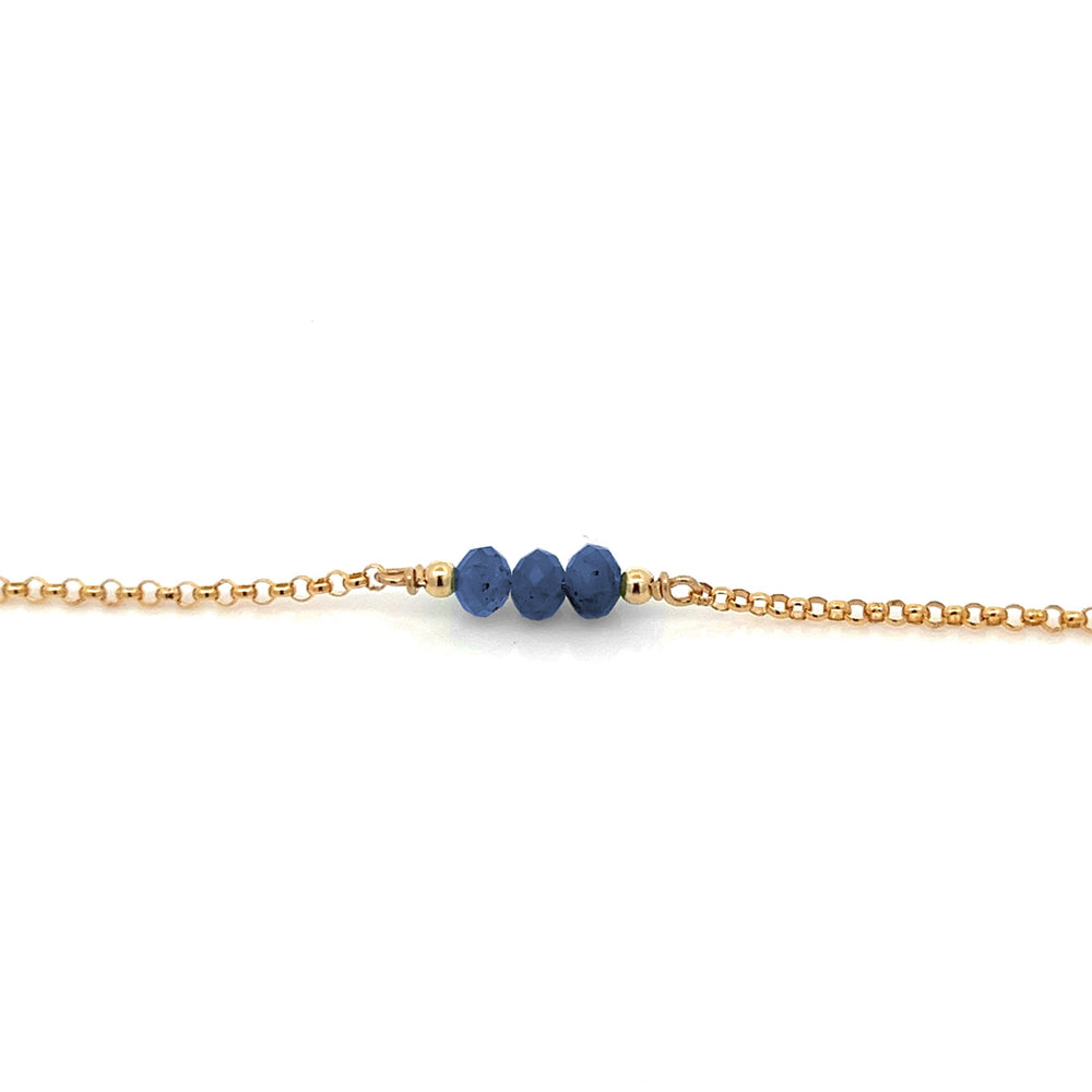 Triple baby birthstone bracelet by PHYNE featuring sapphire gemstones on a delicate silver chain.