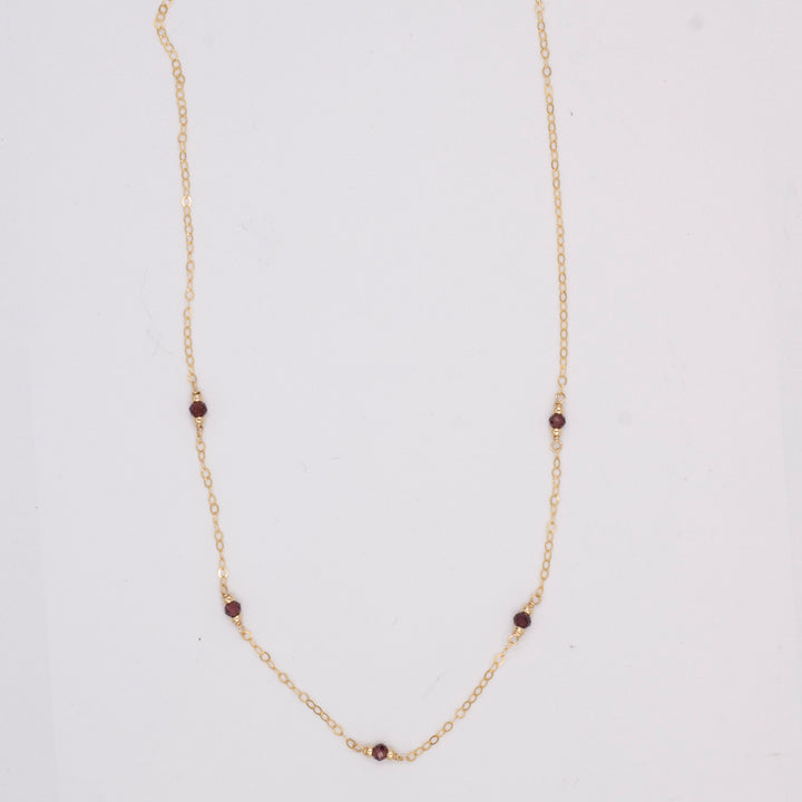 golden rondelle necklace - garnet coin charm - workshopunderground.com