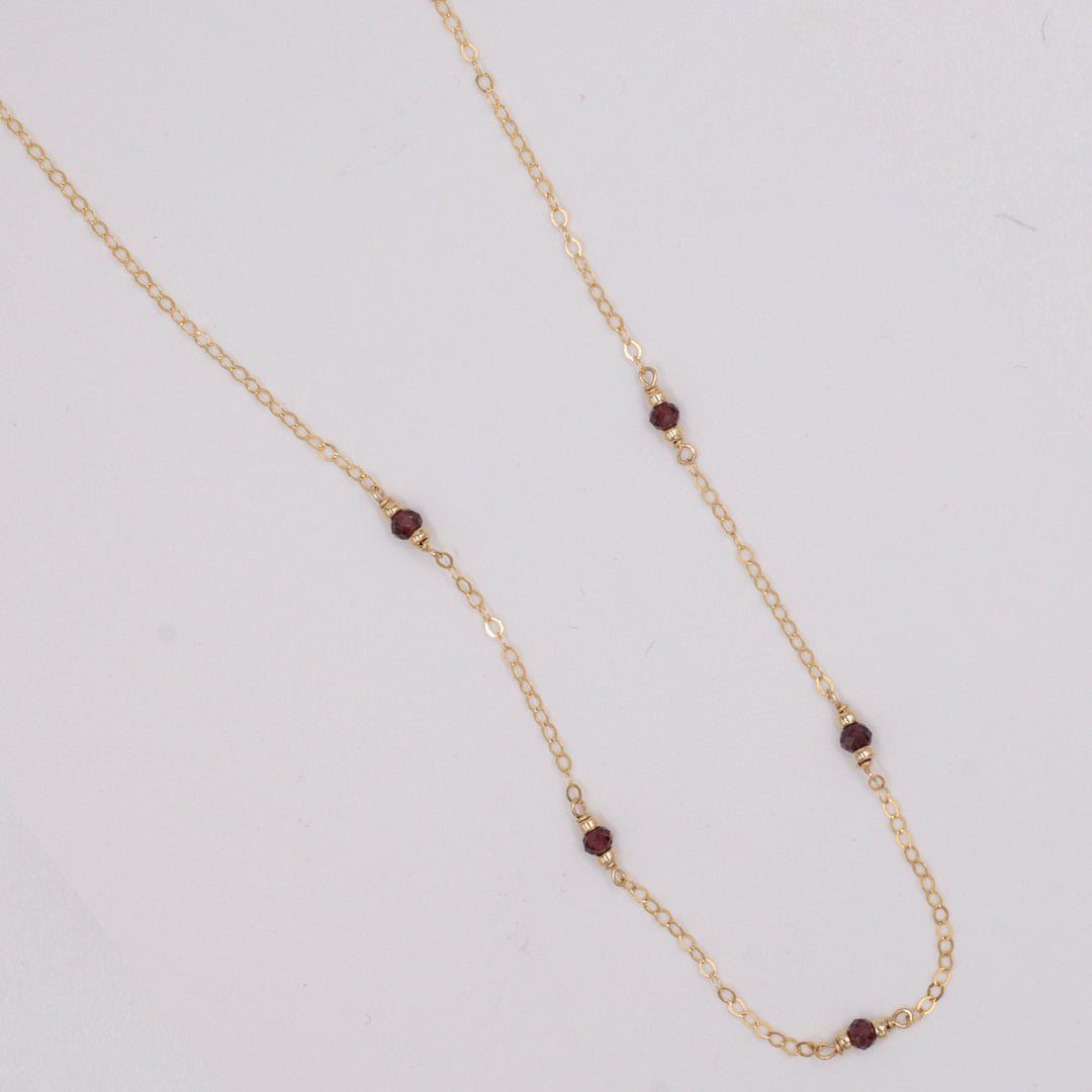 golden rondelle necklace - garnet coin charm - workshopunderground.com